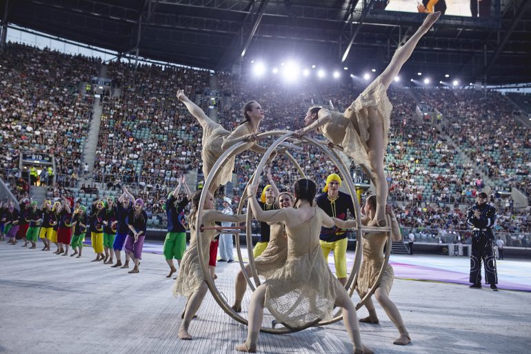 Photo of athletes performing using a large wheel