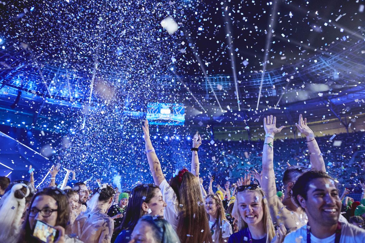 Photo of people smiling with confetti in the air