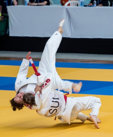 Photo of woman taking down another woman in Ju-jitsu