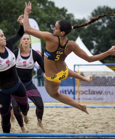 Photo of women playing handball on sand