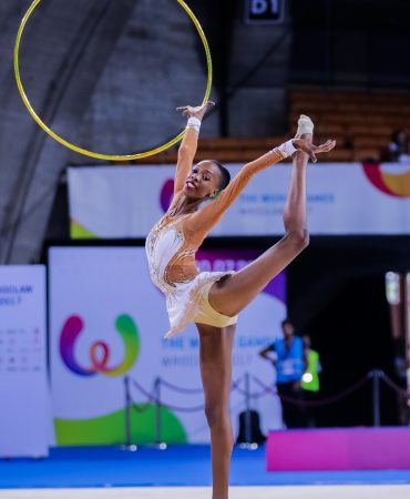Photo of woman doing gymnastic routine with hoop
