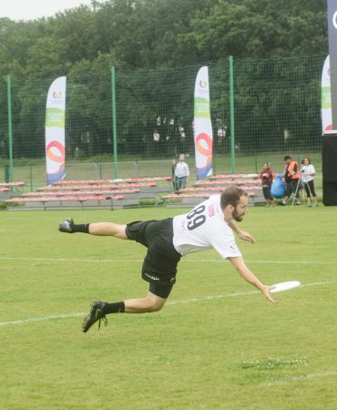 Photo of man grabbing disc in mid air